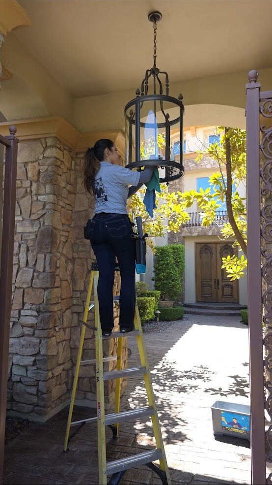 Interior window cleaning from a ladder in a two-story Las Vegas entryway