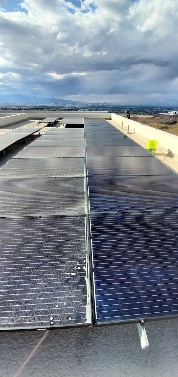 Dusty rooftop solar panels before a Las Vegas cleaning