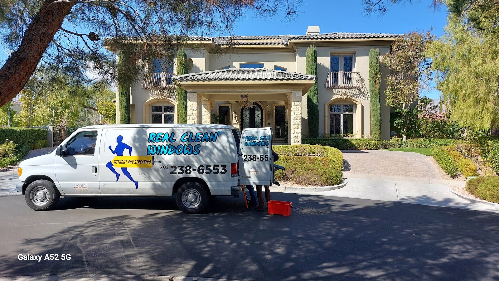 Professional window cleaner working on a Las Vegas home