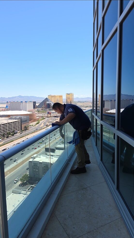 Technician cleaning upper-floor windows above the Las Vegas valley